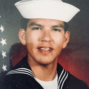 portrait photo of a young man in a US Navy sailor uniform