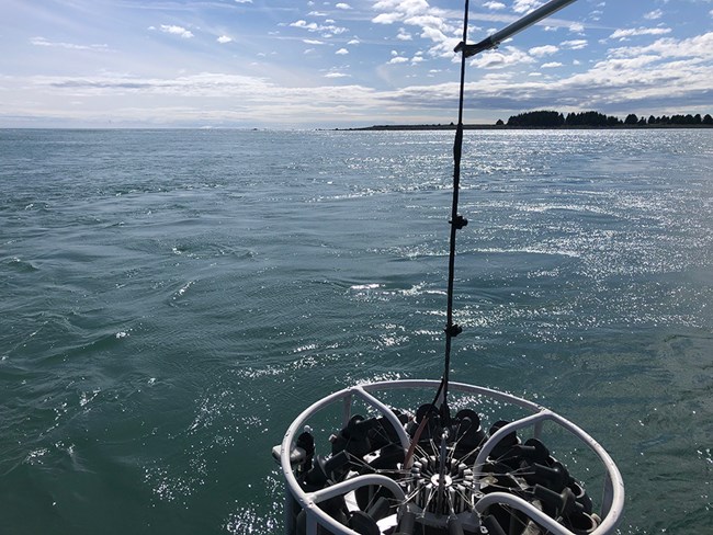 A ctd sonde being lowered into the ocean.