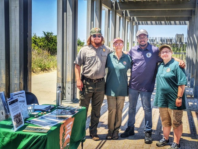 A Park Ranger, two volunteers and a Community Volunteer Ambassador pose for a picture