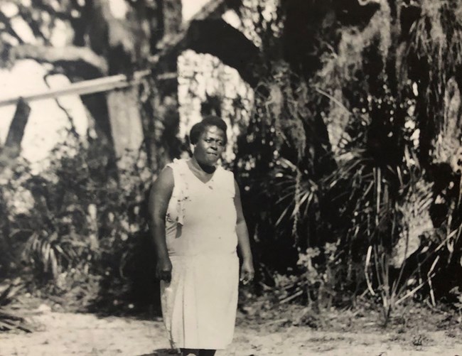 Eldora Caretaker A caretaker walks past saw palmetto at the historic Eldora community.
