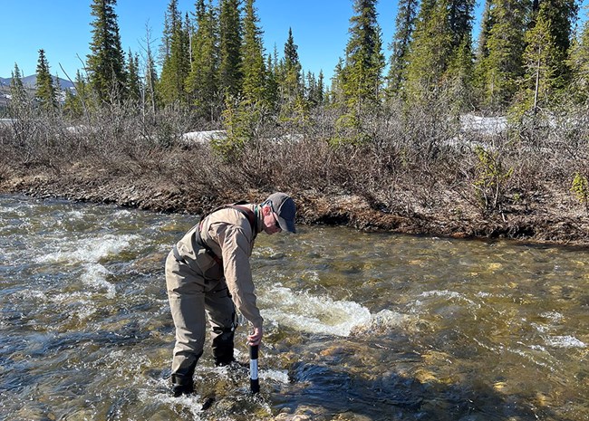 Carey_USGS_StreamMonitoring2_web A scientists takes measurements of a stream.