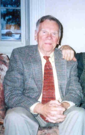 an elderly white man in a suit jacket