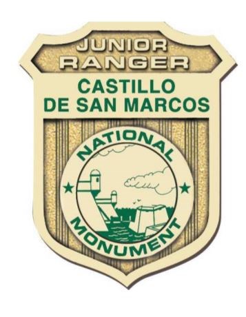 Golden badge with image of fort and words, Castillo de San Marcos Junior Ranger.