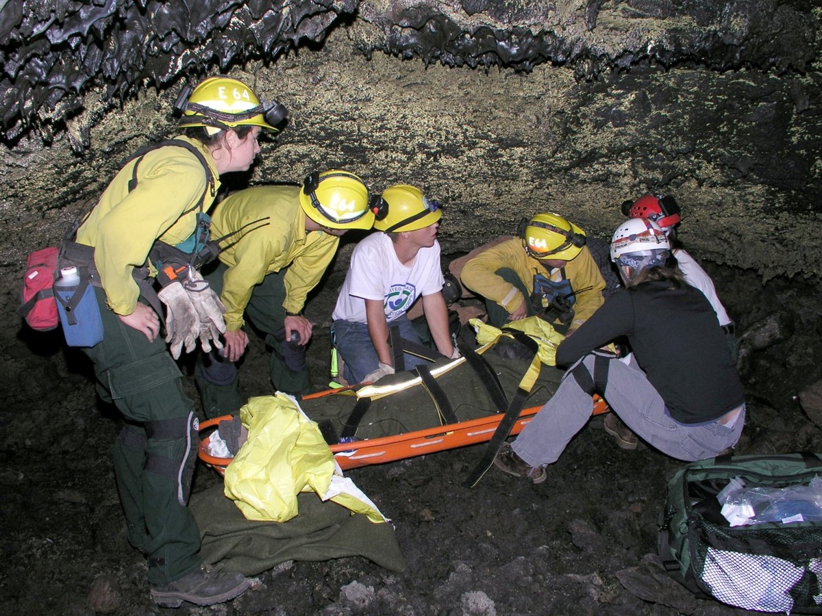 team of people in a cave conducting a rescue practice