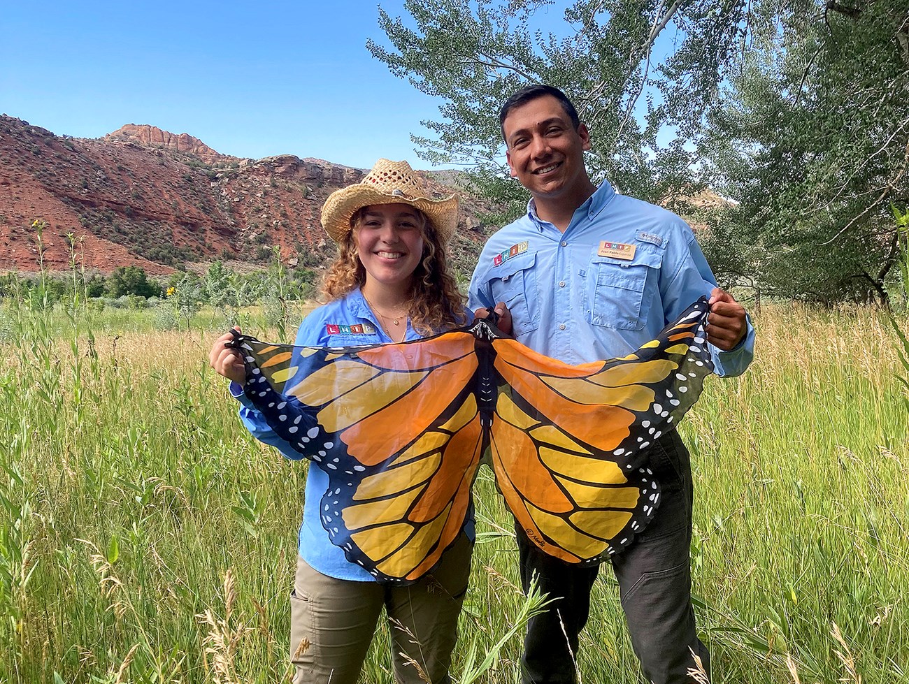 Authors Cavezza and Esparza-Limón holding a monarch butterfly flag