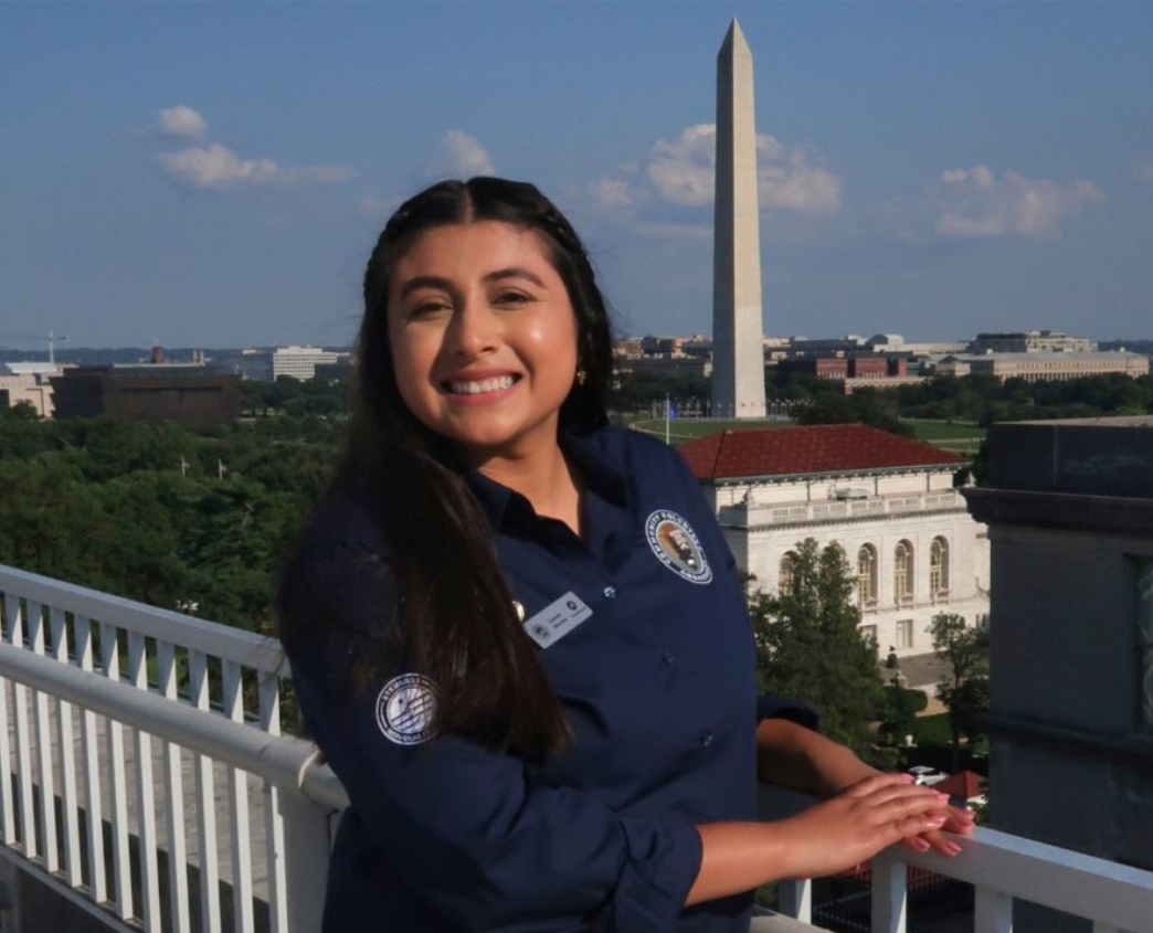 Celeste Morales on a rooftop with the Washington Monument in the backround