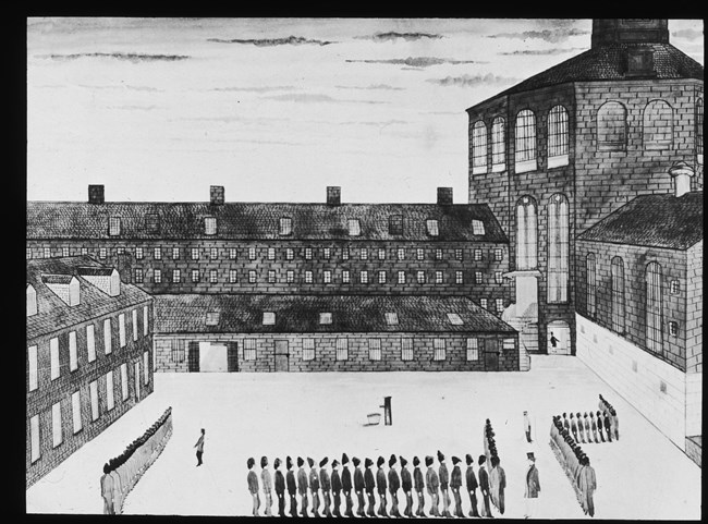 Drawing of a large prison yard enclosed by tall brick buildings. Organized lines of people walk along the front.