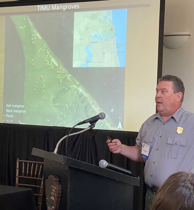 Ches Vervaeke at the Timucuan Science Symposium Man at a podium