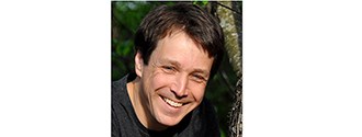 Chris Tullar Headshot of a smiling man with brown hair