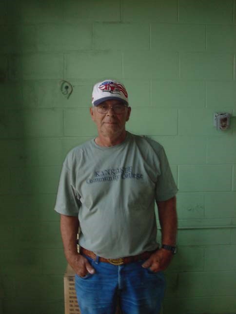 an old man in a baseball cap and tee shirt