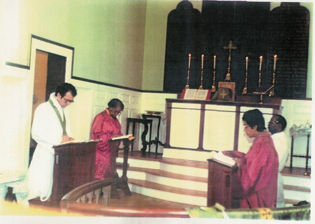 men and women kneeling at a church service