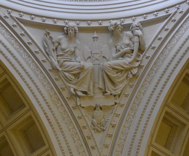 White granite pendentive architecture of two allegorical women