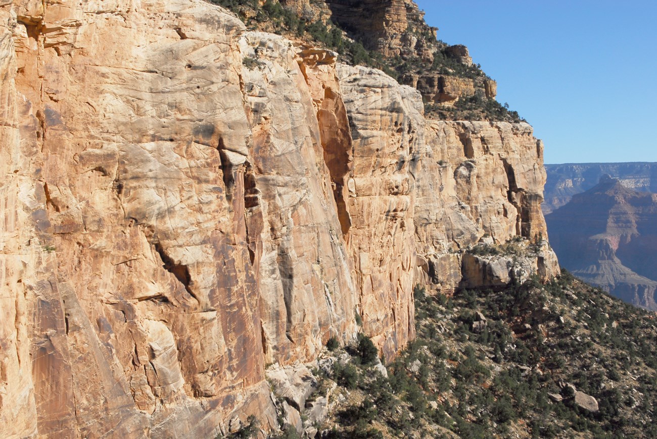 Photo of a massive sandstone cliff.