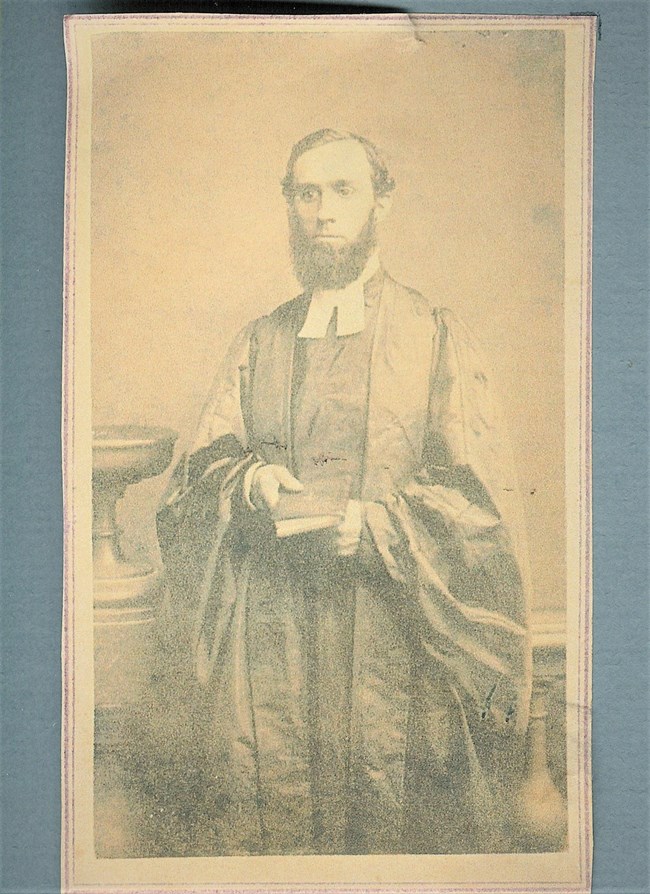 Coffeyrobesstraightened Photo of man, bearded, in black robes, holding a book
