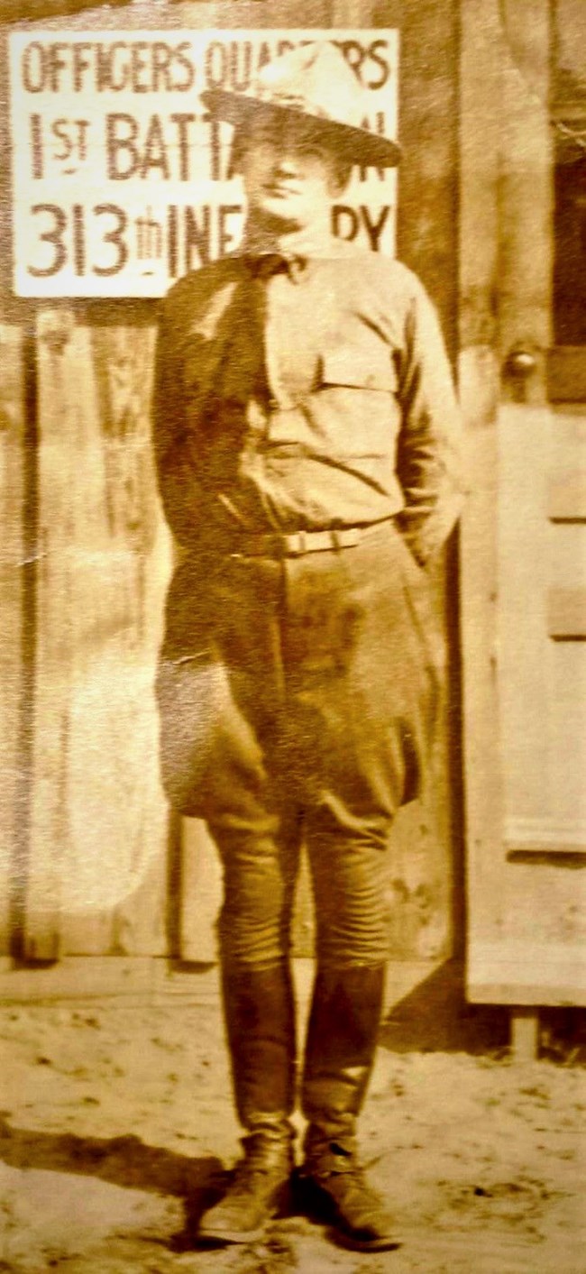 Col. Ramsey Flynn, of Mt. Vernon, during Worled War I Man, standing, in military uniform, boots and hat, in front of a building, with a sign