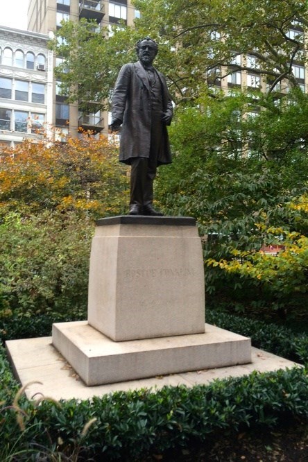bronze statue of a man standing on a pedestal