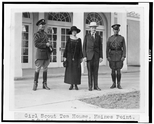 Coolidge Girl Scout Teahouse Grace and Calvin Coolidge standing outside the teahouse with two uniformed men on either side