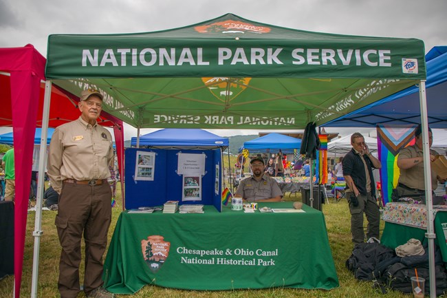 Lowell Volunteering Festivals National Park Service volunteer and ranger with an informative table