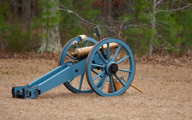 Grasshopper Cannon with blue paint on wheels.