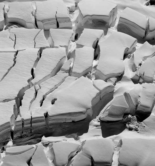 Black and white image of glacier crevasses.