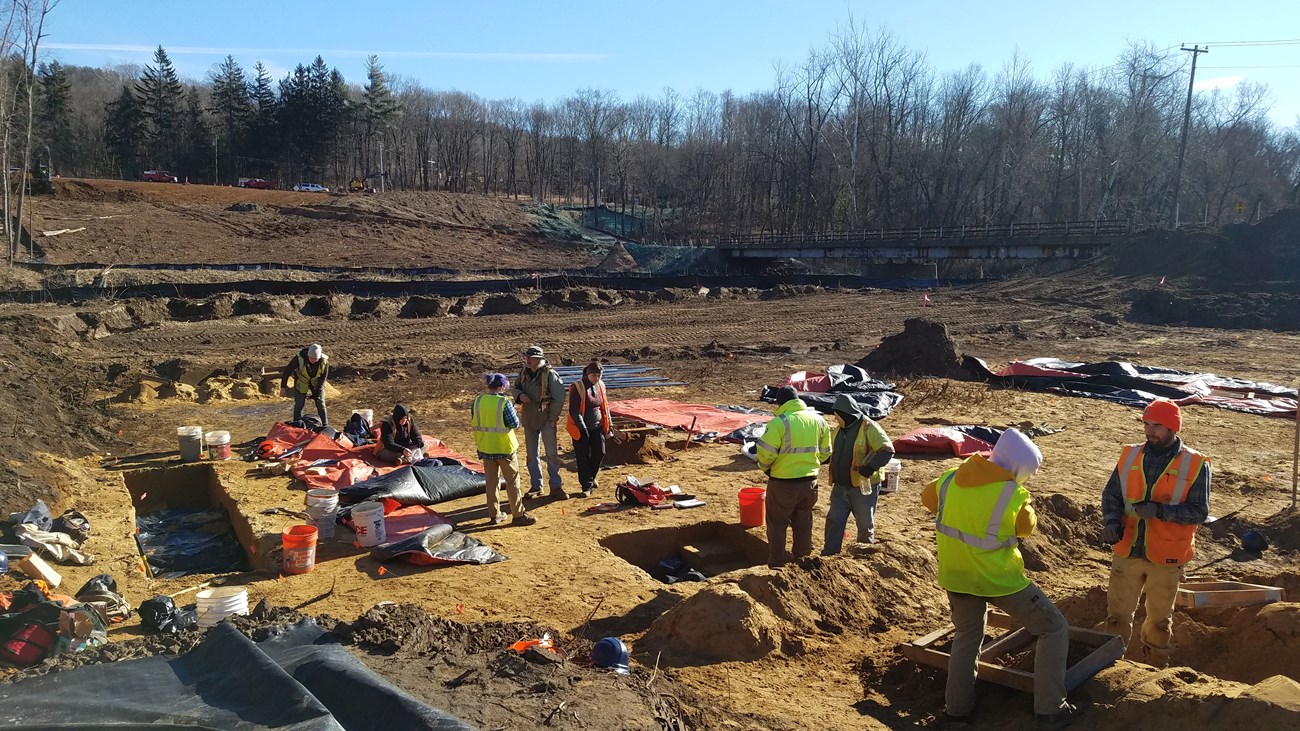 Crew Excavating at site along the Farmington River An archeological crew works on excavating a site in the winter