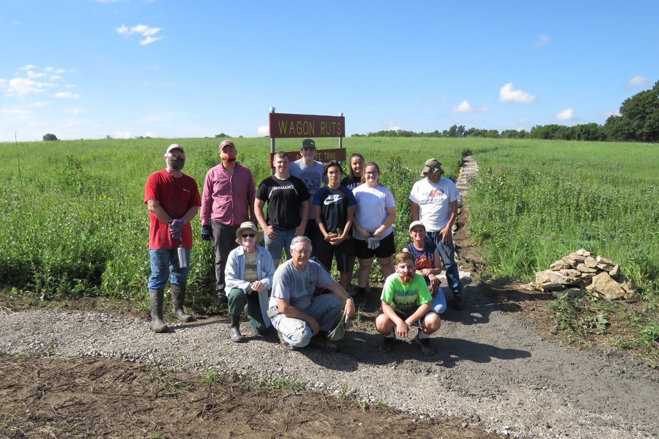 A group of people in front of a constructed trail.