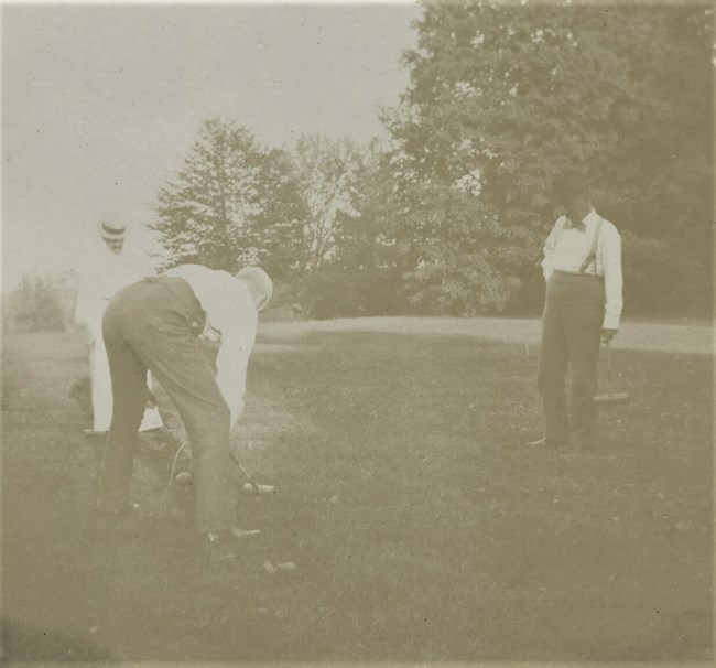 Croquet on lawn A black and white photograph of two men playing croquet.