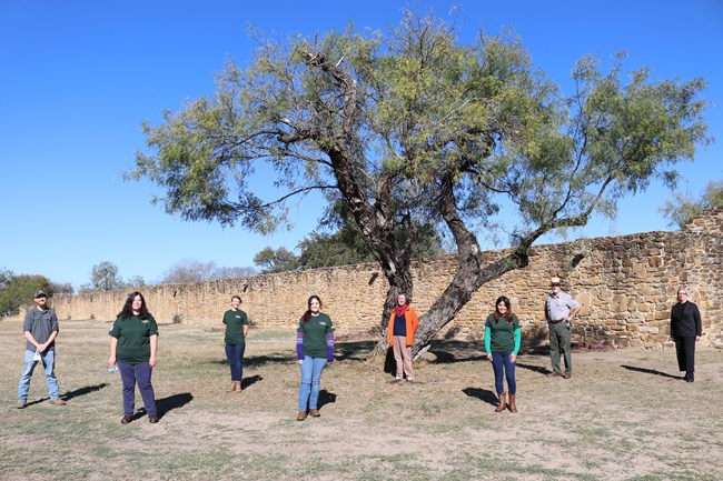 Cultural Landscape Apprentices and Park Rangers pose in front of Mission San Jose.