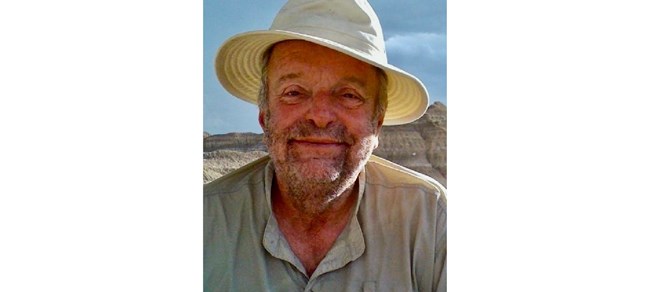 David C. Culver Culver outside in a sun hat, smiling at the camera.