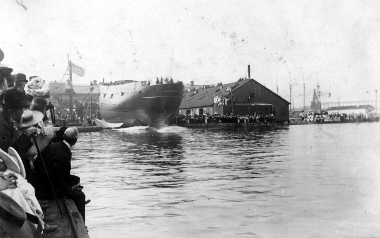 USS CUMBERLAND launching into the water.