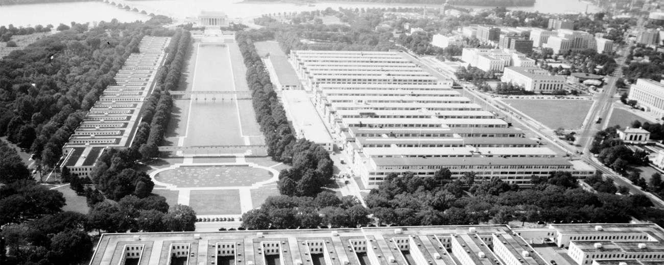 Washington, DC during World War II Black and white aerial photo of a city showing several buildings, a large greenspace, and a river in the background.