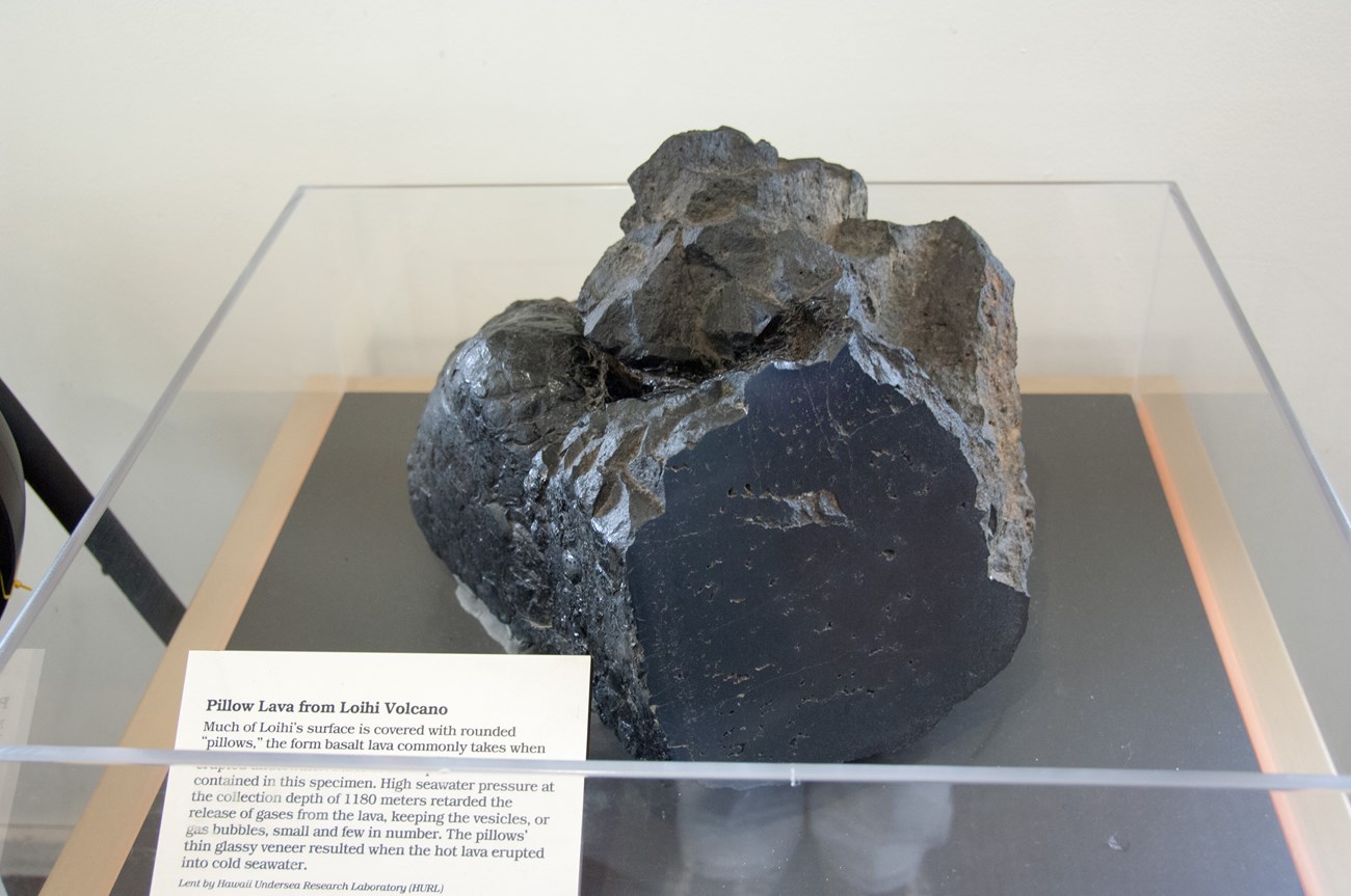 photo of a dark rock on display in a visitor center