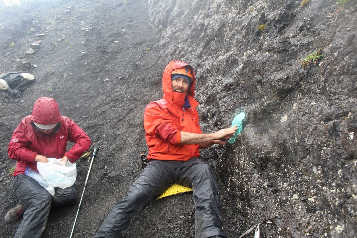 two people in the field at a fossil site