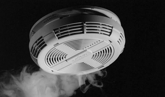 Smoke detector with alarm. Smoke detector with smoke around it.