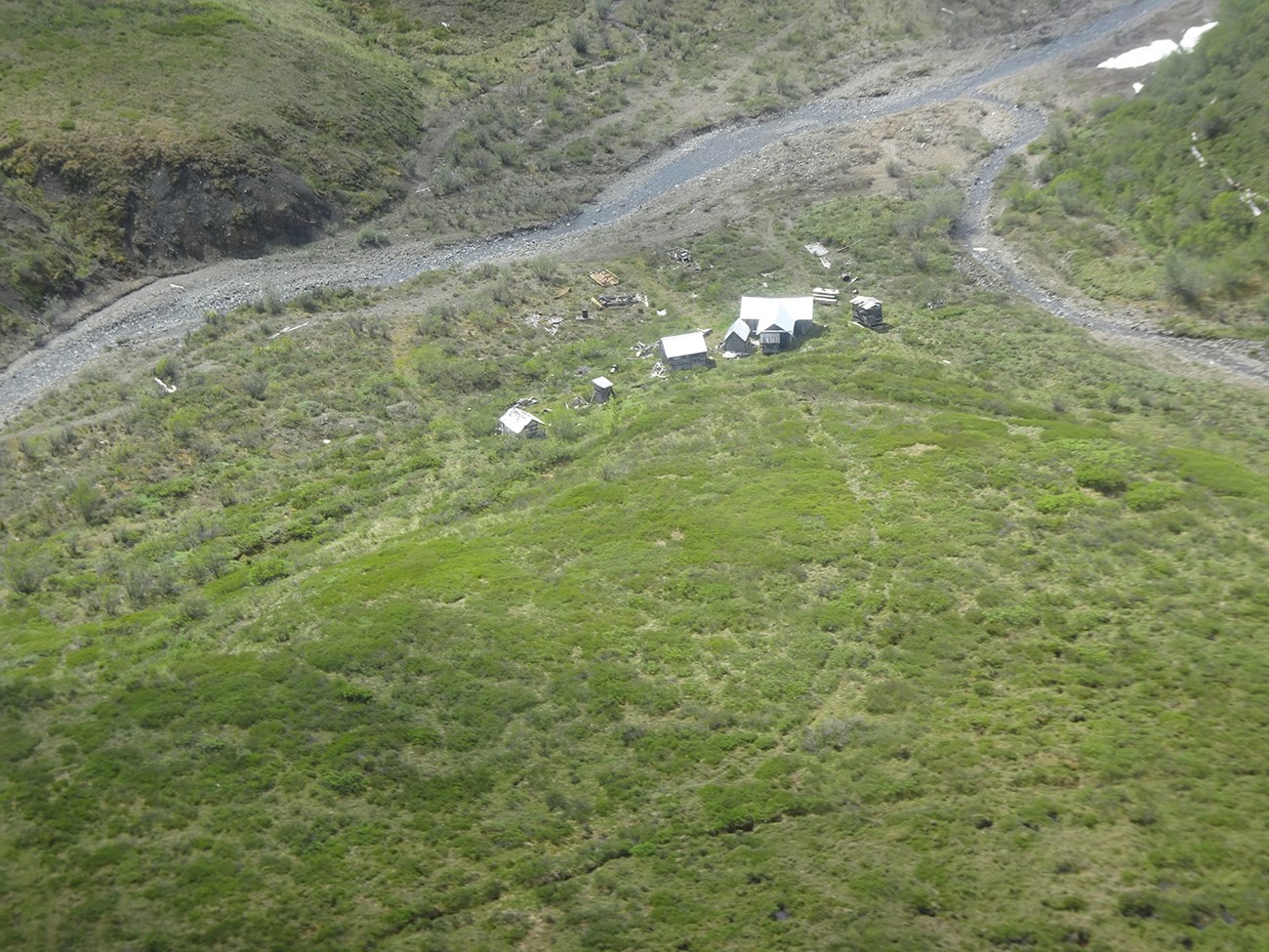 DSC00662_web An aerial view of mining sites on the tundra near a river.