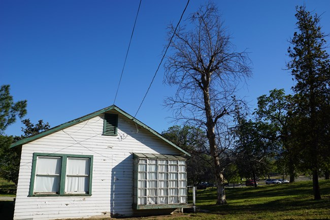 A modest white house with a large glass block window