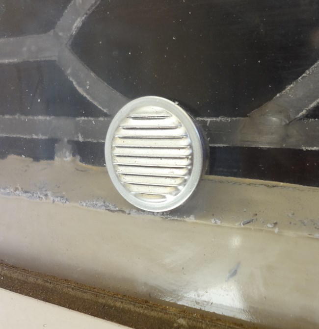 Circular metal window vent. Circular metal window vent.