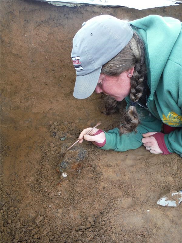 Bundle of materials found with human remains being carefully excivated from the burial location.