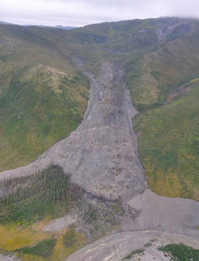 An aerial view of a large landslide caused by thawing permafrost.
