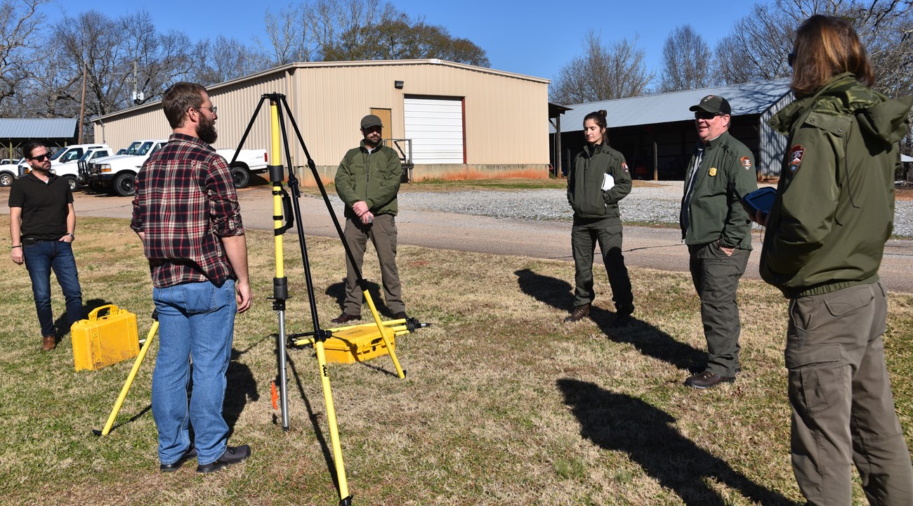 Survey Training at SECN Office People standing around a tripod.