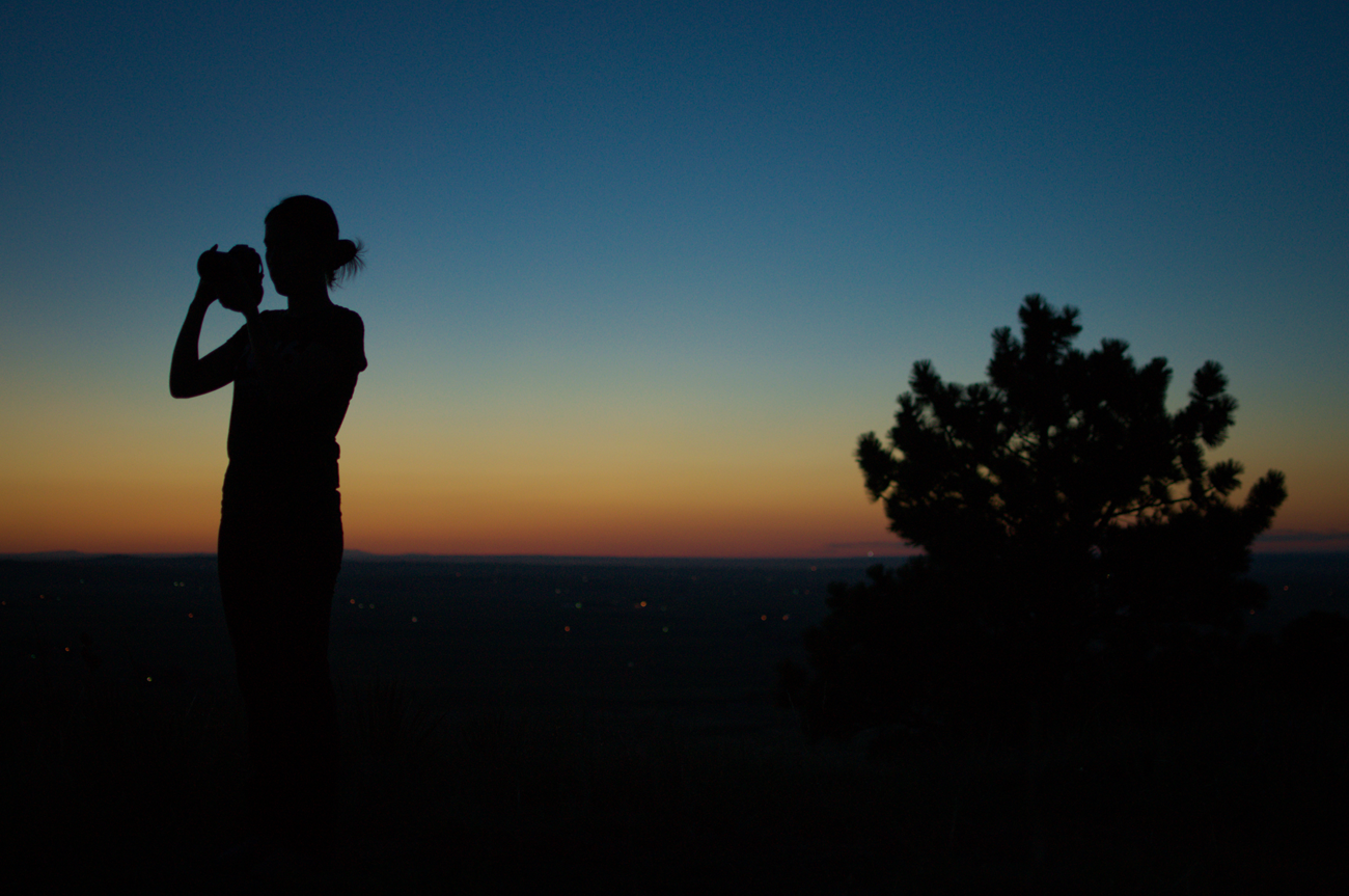 Silhouette of Li Wei taking a photo with the night sky as a background