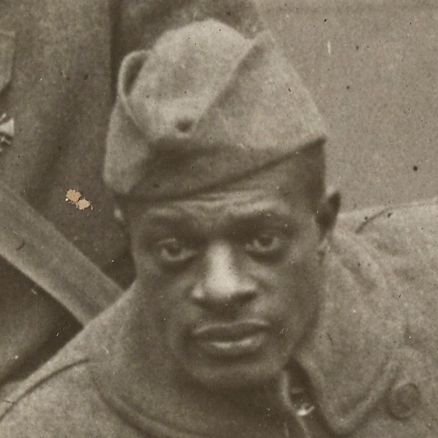 African American Soldier wearing World War One uniform looking at the camera
