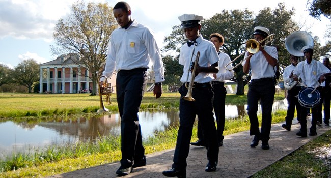 Young jazz band walking along a sidewalk