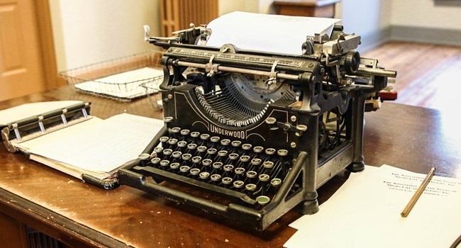 Typewriter on a desk with papers