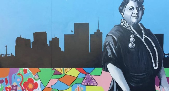 Mural of Maggie Walker with the Richmond city skyline