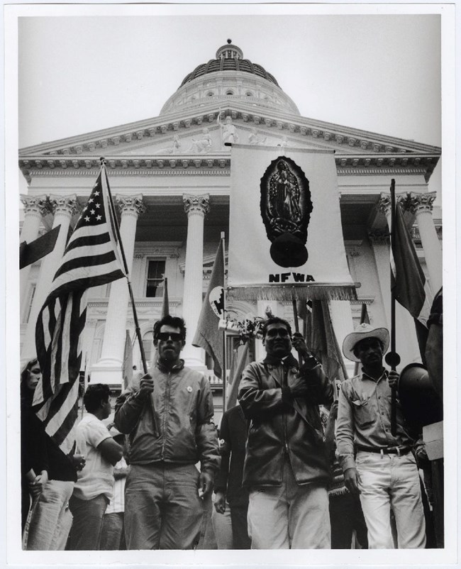 On Easter Sunday, the marchers and thousands of supporters gather in Sacramento. Visible in the photo is a banner with Our Lady of Guadalupe and an American flag.