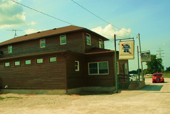 lt= Illustration of a large brown building.