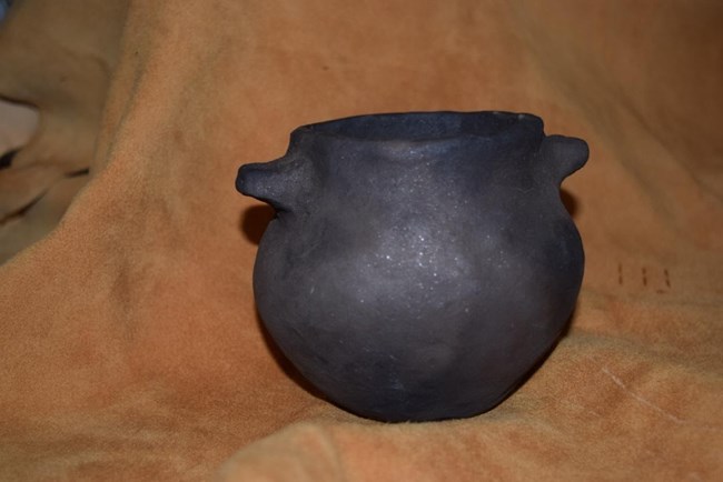 Debra Martin Colonoware A simple, black pot with two handles.