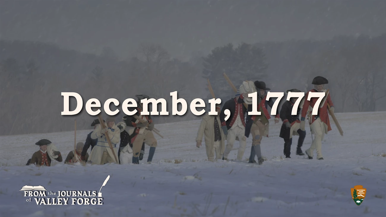 December 1777 From the Journals of Valley Forge Soldiers in Revolutionary War uniforms walk through a snowy field carrying canvas and wooden posts. Text superimposed over the image reads “From the Journals of Valley Forge.” An illustration of an open book is above the word “from”