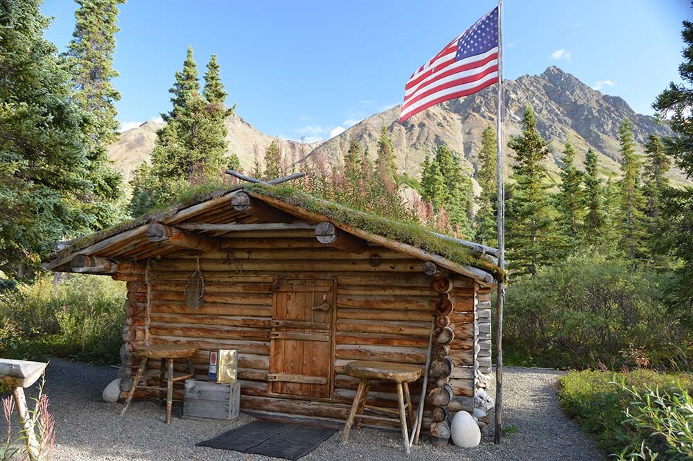 A log cabin with a flag flying.